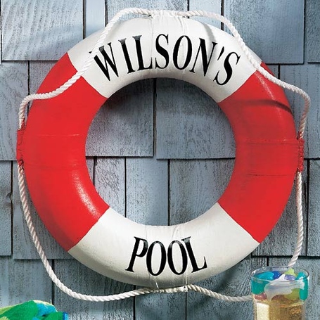 Life preserver personalized with 'WILSON'S POOL' written around it, hanging on display