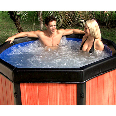 A man and woman sitting in the Spa-N-A-Box portable spa